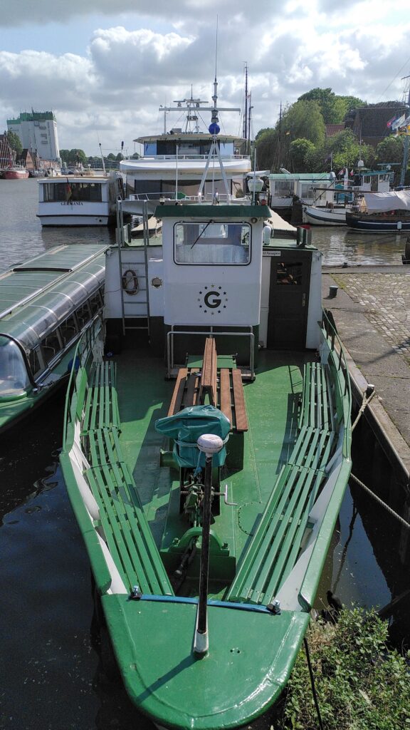 Green and white boat with a logo that looks surprisingly similar to the Google ‘G’