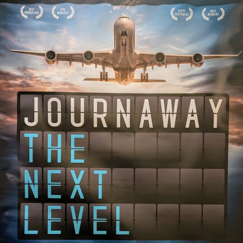 Fictional film poster showing an airplane getting ready to land on the runway, coming towards the viewer, against a high-contrast sunrise sky. The font resembles an airport arrivals table, capital letters on dark rectangle tiles, spelling: JOURNAWAY – THE NEXT LEVEL