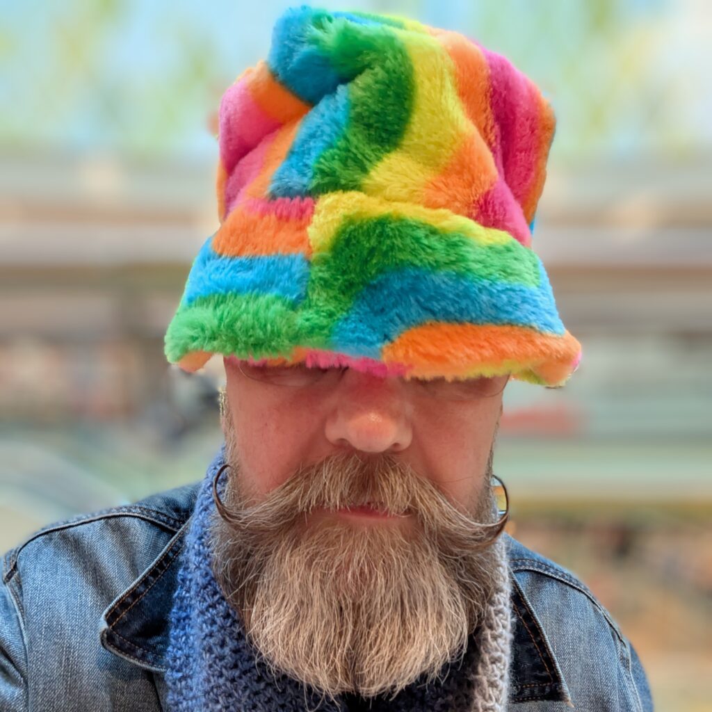 Yours truly wearing a colourful fluffy hat